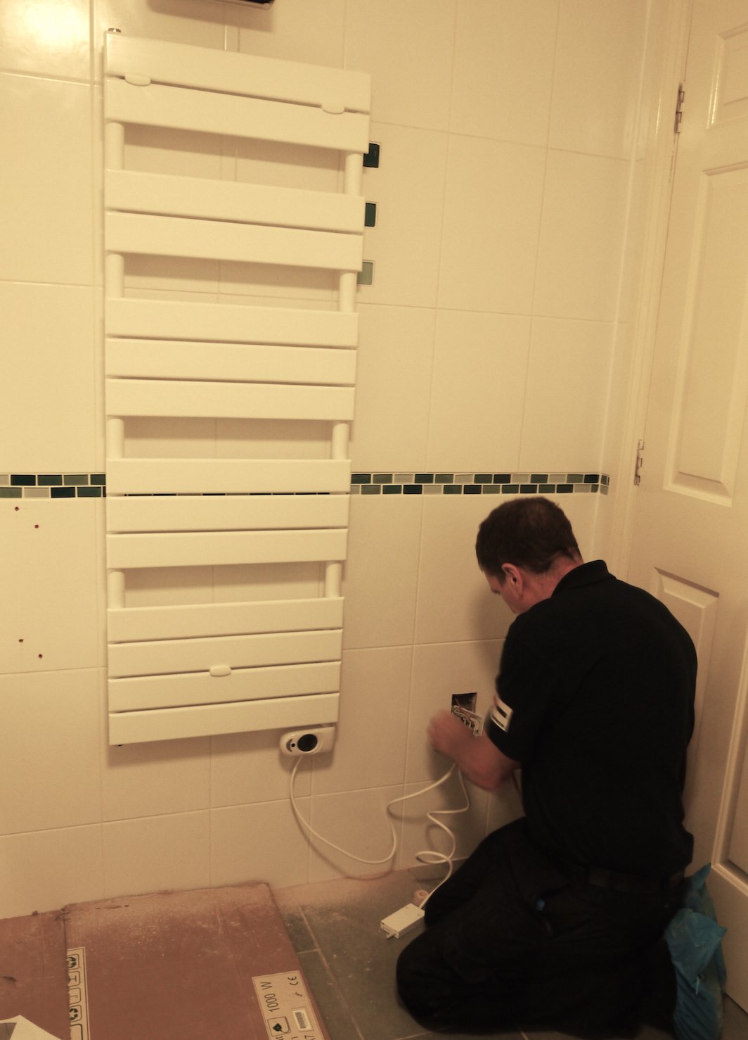 plumber installing bathroom radiator